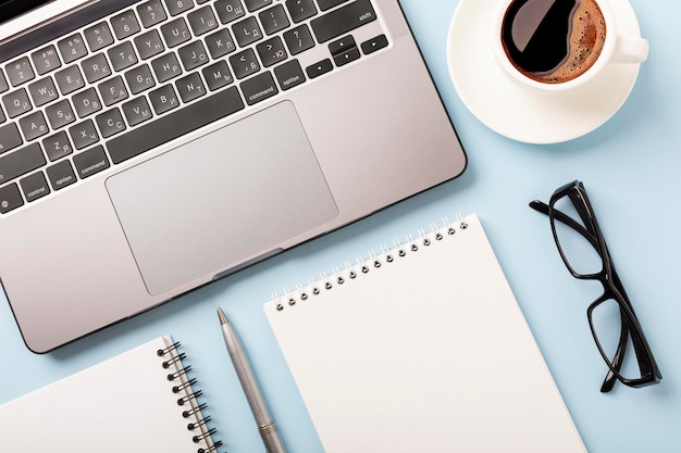 Business desk workplace and office objects over blue backdrop Top view flat lay with copy space for your text