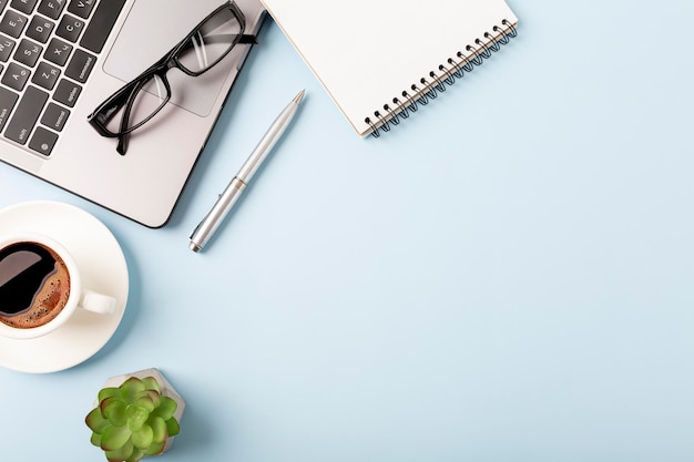 Business desk workplace and office objects over blue backdrop Top view flat lay with copy space for your text