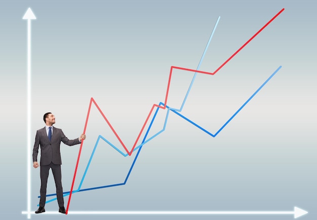 business, development and people concept - smiling man holding graph line over chart background