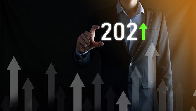 成功への事業開発と成長する成長2021年の概念。2021年の概念で事業成長グラフを計画する。ビジネスマンの計画と彼のビジネスの肯定的な指標の増加。