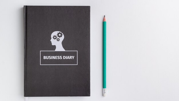 business diary and pencil on white background isolated