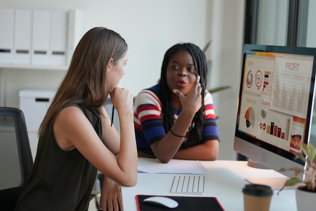 Business discussions Shot of businesswomen brainstorming in an office Two women working at the office