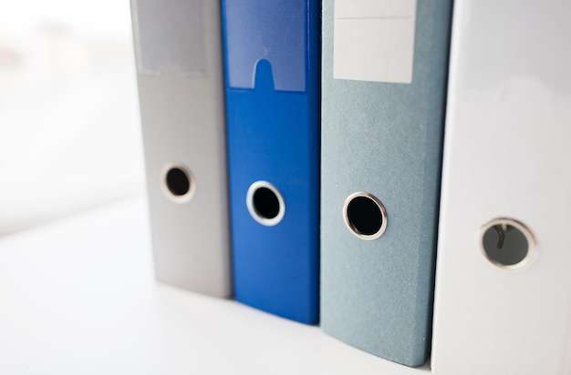 business, document, paperwork, office supply and education concept - close up of ring binders on table