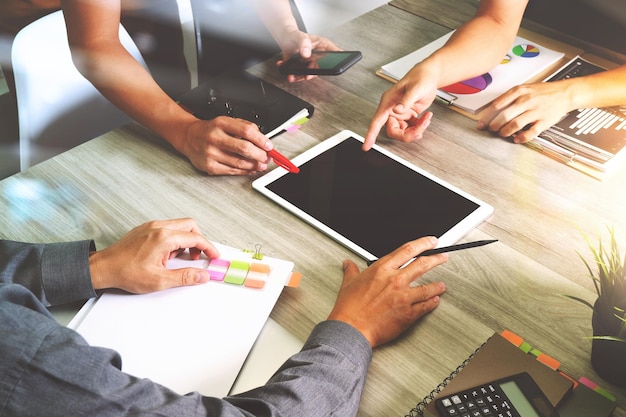 Business documents on office table with smart phone and laptop computer and graph business