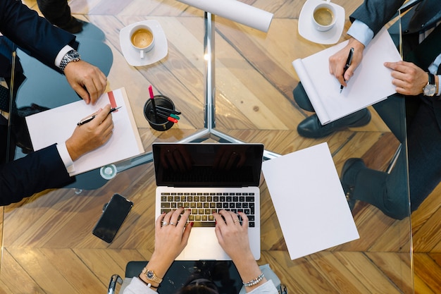 Business documents on office table with smartphone and laptop