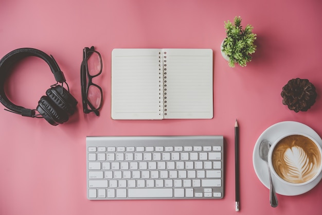 business, education concept. Office supplies, blank screen notebook eyeglasses on a pink table.top v