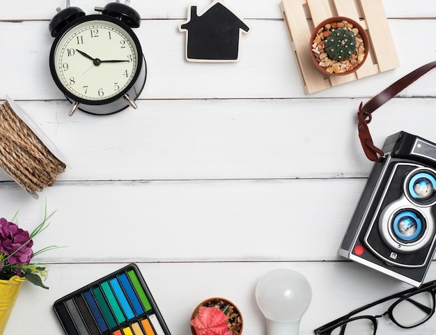 Business or education idea for create inspiration concept flat\
lay clock glassescameracactusrope pencil with wood white background\
for create idea for business or design thinking time