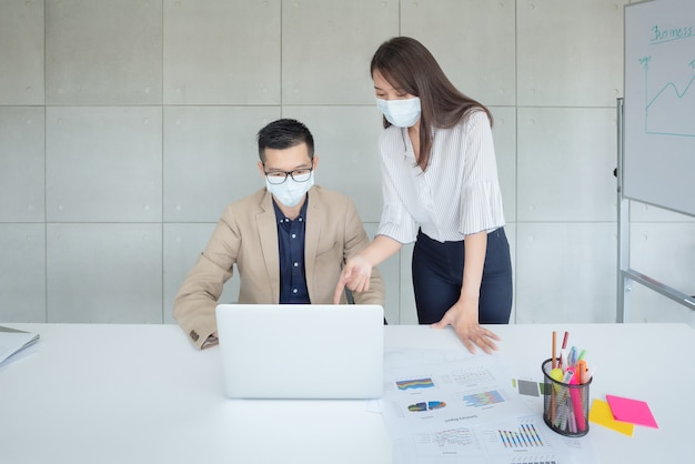 Business employees wearing mask during work in office to keep hygiene follow company policy. Preventive during the period of epidemic from coronavirus or covid19.