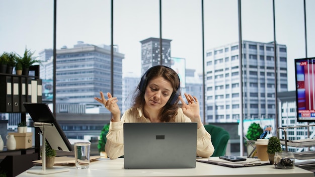 business entrepreneur enjoys working with music on her headset