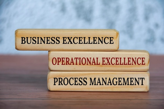 Business excellence operational excellence and process management text on wooden blocks Operational excellence and business strategy concept