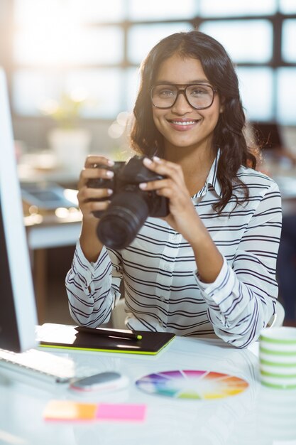 Business executive checking photos in camera