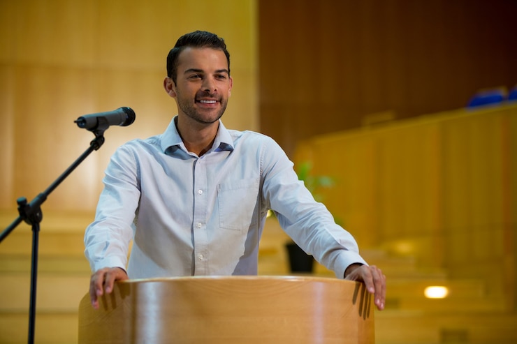Photo business executive giving a speech at conference center