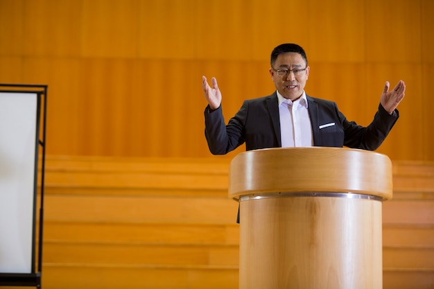 Business executive giving a speech at conference center