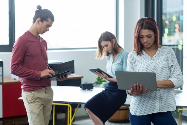 Business executive using laptop and digital tablet