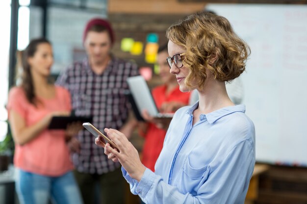 Business executive using mobile phone in office