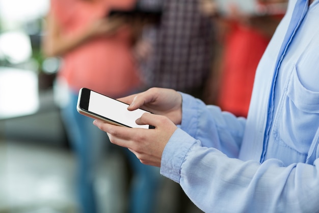 Business executive using mobile phone in office