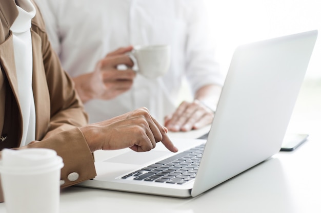 Photo business executives at a cafe or working space and discussing a project