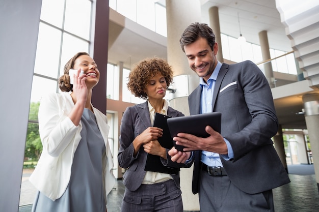 Business executives discussing over digital tablet