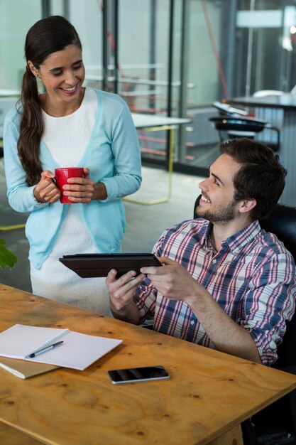 Business executives discussing over digital tablet