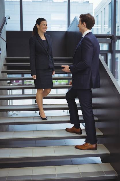 Business executives having a conversation on stairs