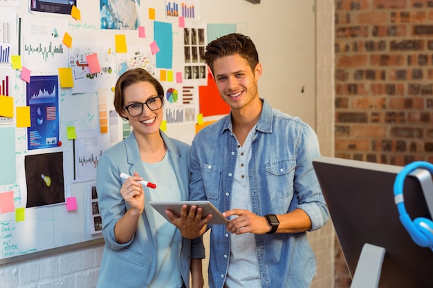 Business executives holding digital tablet in office