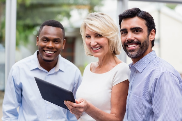 Business executives holding digital tablet