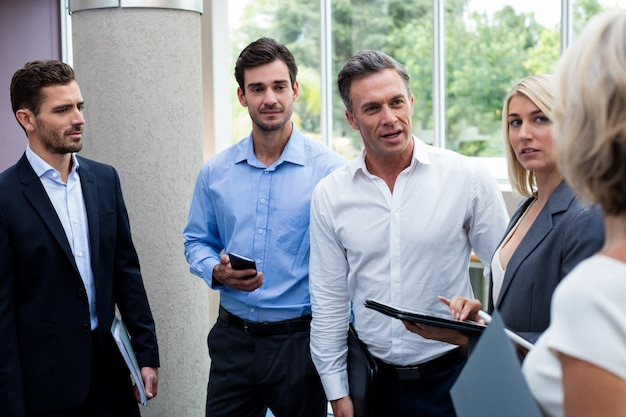 Business executives interacting in a conference center lobby