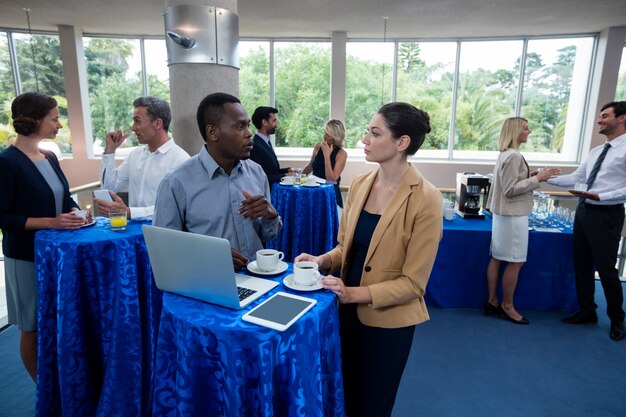 Photo business executives interacting with each other during break