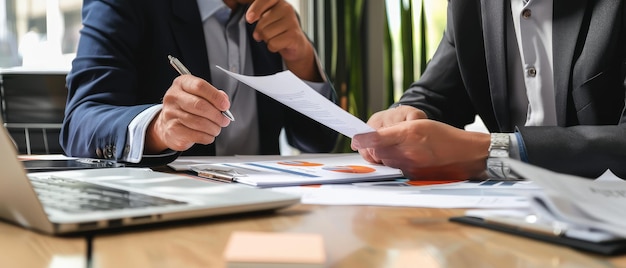 Business Executives Shaking Hands Over Meeting Table