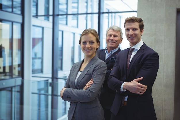 Business executives standing with arms crossed in the office