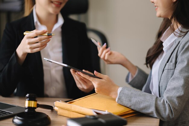 Photo business and female lawyer or judge consult having team meeting with client law and legal services conceptcustomer service good cooperation in office