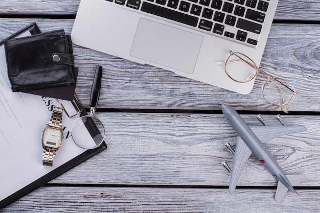 Business and finance accessories on wood. Top view flat lay. Laptop with clipboard and copy space.