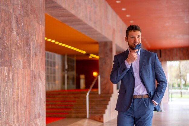 Business or finance corporate man at the entrance of an event\
in a hotel