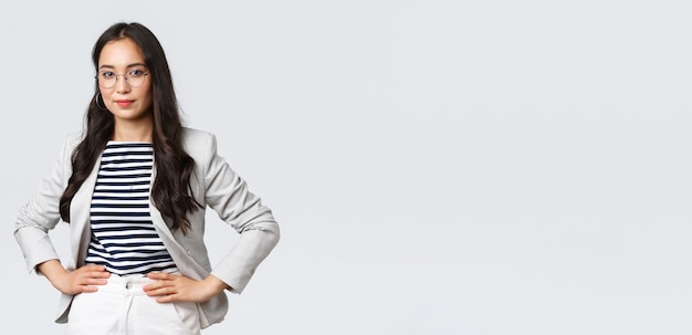 Business finance and employment female successful entrepreneurs concept Confident businesswoman in glasses and white suit ready for meeting smiling pleased standing determined