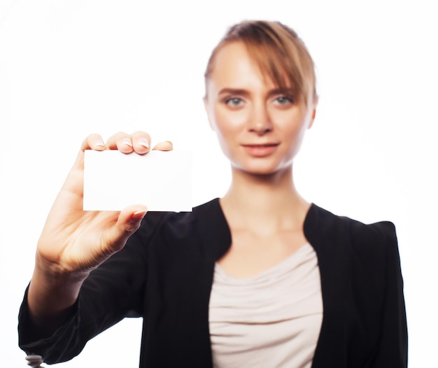 Photo business, finance and people concept: smiling business woman handing a blank business card over white background. positive emotion.