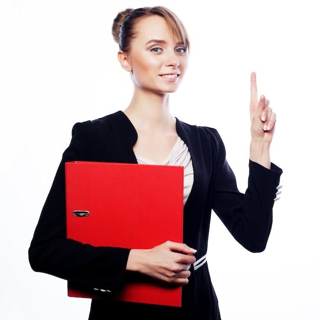 Business, finance and people concept:  young business woman pointing at white background.