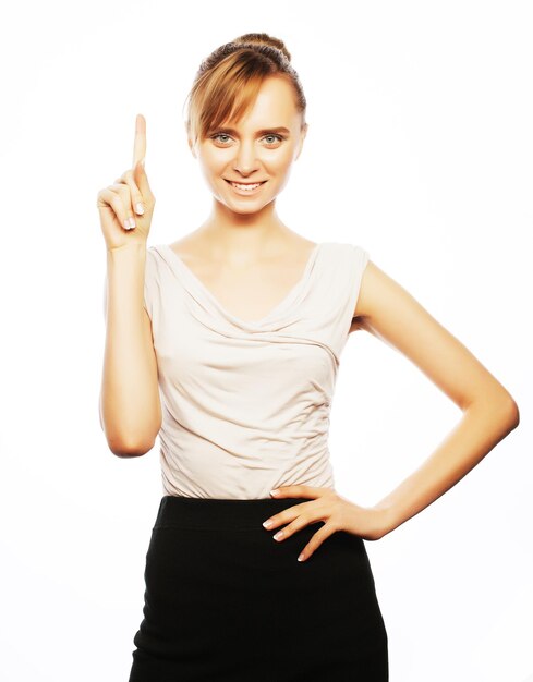Photo business finance and people concept young business woman pointing at white background