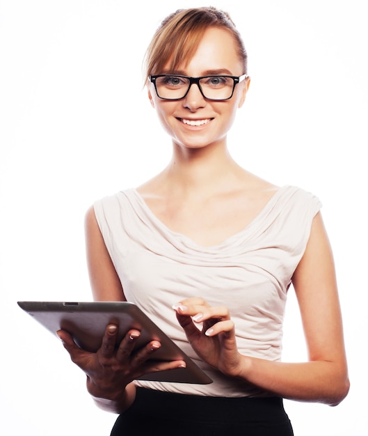 Business, finance and people concept: young business woman wearing glasses  working on tablet