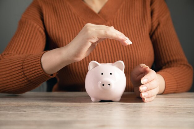 Business finance and saving money investment concept woman hand holding piggy bank