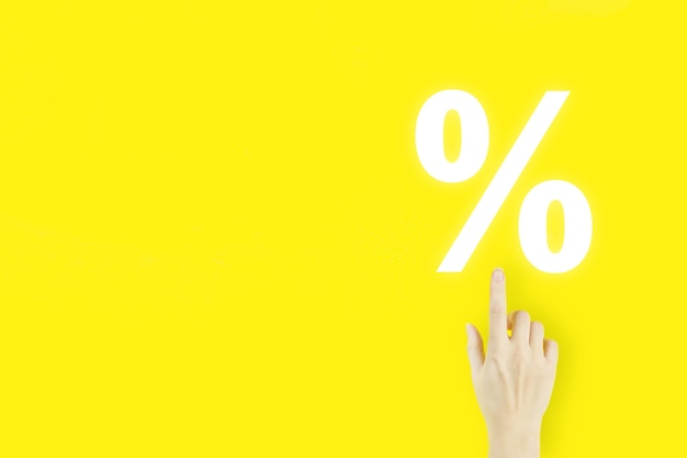 Business. Finance. Wealth. Young woman's hand pointing finger with hologram Interest rate on yellow background. Successful international financial investment concept.