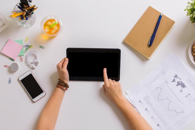 business, freelance and technology concept - woman hands with tablet pc computer and notebook at office table