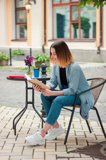 A business girl with a notebook sits on the steps Businesswoman Business style Student Psycholog