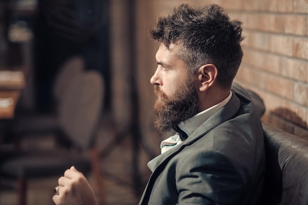 Business on the go Confident bar customer sit in cafe Businessman with long beard in cigar club Date meeting of hipster awaiting in pub Bearded man rest in restaurant