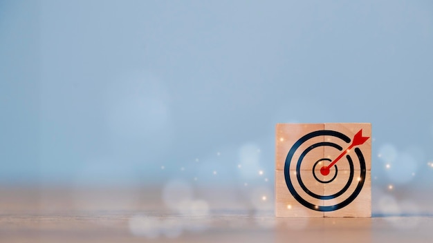 Business goal and success concept Focus on a goal and achieve a successful business Initiation for planning to reach the target Darts target aim icon on wooden cubes with Copy space