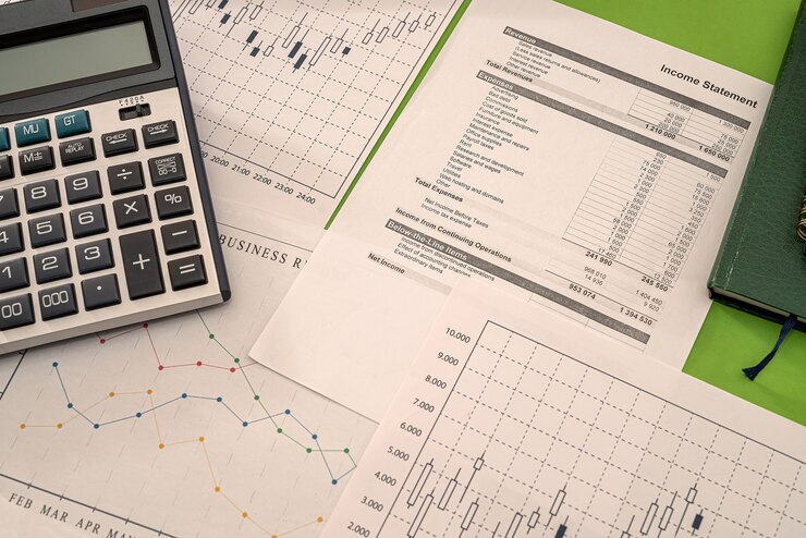Photo business graphs money calculator pen notebooks lying on the table. graphs concept
