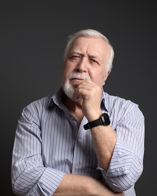 Business, gray-haired man  seriously looking