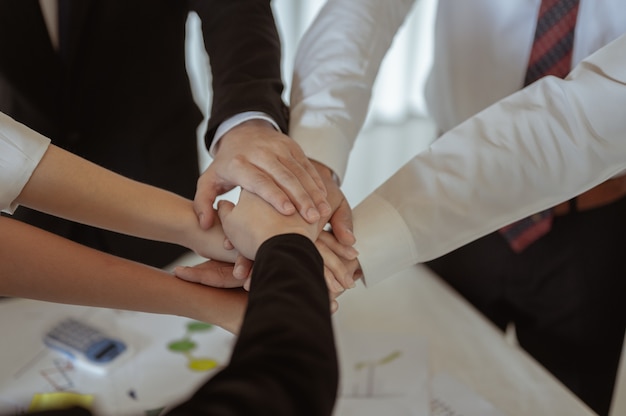 Business group with hands together - teamwork concepts