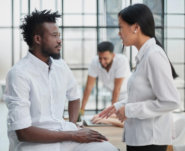 Business handshake  business people shaking hands handshake between business man and woman indoors