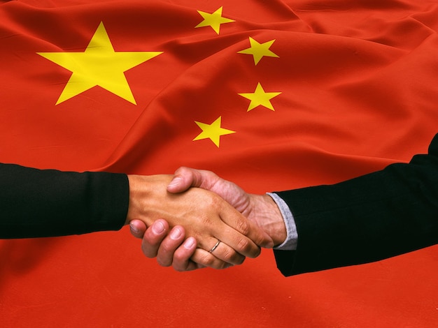 Photo business handshake on china flag background