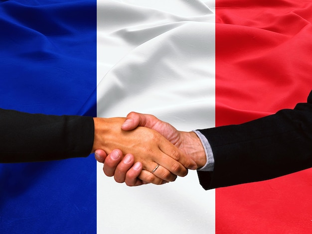 Photo business handshake on france flag background